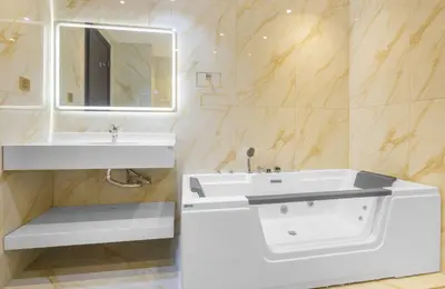 a white bathroom with a sink and a mirror at Lux 3BHK With Pvt Jacuzzi in Marina in Dubai