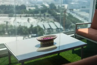 a white table with a bowl on top of a window at Lux 3BHK With Pvt Jacuzzi in Marina in Dubai