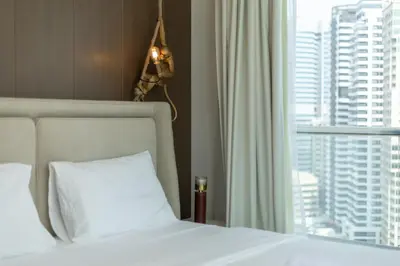 a bedroom with a white bed and a window at Lux 3BHK With Pvt Jacuzzi in Marina in Dubai