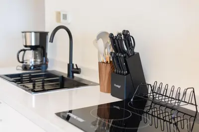 a kitchen counter with a sink and utensils at Lux 3BHK With Pvt Jacuzzi in Marina in Dubai