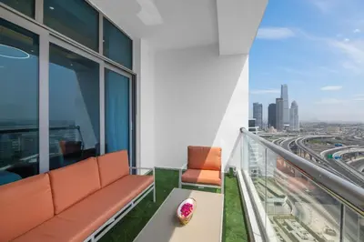 a balcony with a couch and a view of the city at Lux 3BHK With Pvt Jacuzzi in Marina in Dubai