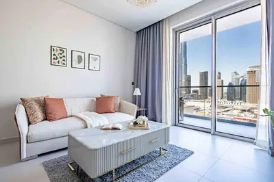 a living room with a couch and a large window at Frank Porter - Vida Dubai Mall in Dubai