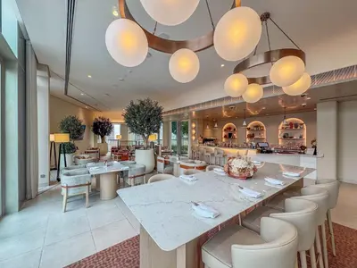 a restaurant with a large table and chairs at Frank Porter - Vida Dubai Mall in Dubai