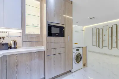 a laundry room with a washer and dryer at Elegant 2-Bedroom Apartment in Marina Heights 1, Dubai Marina in Dubai