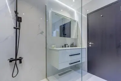 a bathroom with a sink and a shower with a mirror at Elegant 2-Bedroom Apartment in Marina Heights 1, Dubai Marina in Dubai