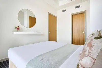 a bedroom with a white bed and a mirror at Frank Porter - Aykon City, Business Bay in Dubai