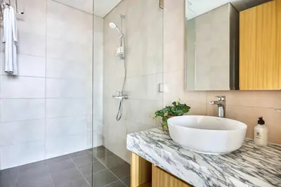 a bathroom with a sink and a shower at Frank Porter - Aykon City, Business Bay in Dubai