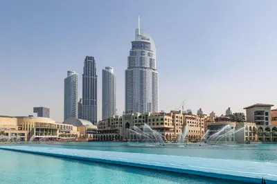a fountain in front of a city with tall buildings at Frank Porter - Loft Tower West in Dubai