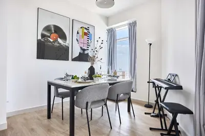 a dining room with a table and chairs at Frank Porter - Loft Tower West in Dubai