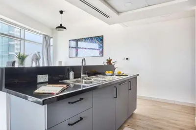 a kitchen with a sink and a counter top at Frank Porter - Loft Tower West in Dubai