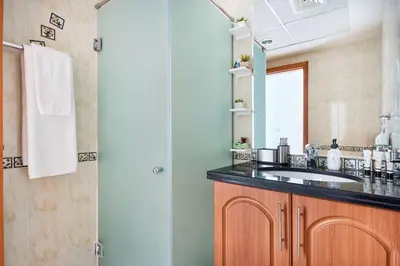 a bathroom with a sink and a mirror at Frank Porter - Damac Waves Tower, Dubai Marina in Dubai