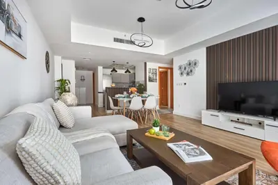 a living room with a couch and a table at Frank Porter - Damac Waves Tower, Dubai Marina in Dubai