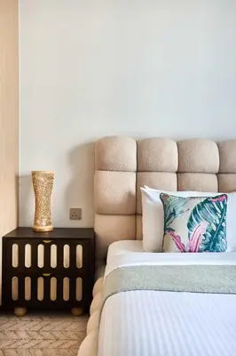 a bedroom with a bed and a vase on a table at Frank Porter - Vida Dubai Mall in Dubai