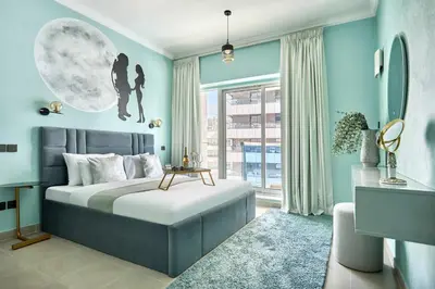 a bedroom with a bed and a large window at Frank Porter - Opal Tower in Dubai