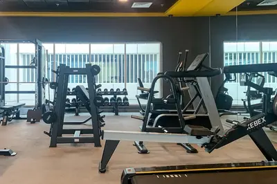 a gym with several tread machines in a room at Frank Porter - Opal Tower in Dubai