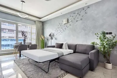 a bedroom with a bed and a couch and a table at Frank Porter - Opal Tower in Dubai