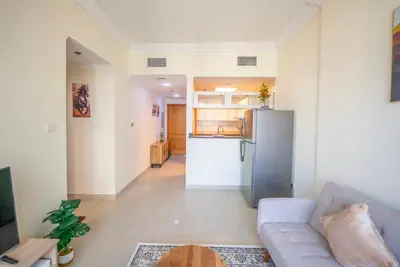 a living room with a couch and a refrigerator at Elegant Marina Living Manchester Tower in Dubai