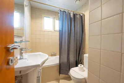 a bathroom with a sink and a toilet and a shower at Elegant Marina Living Manchester Tower in Dubai