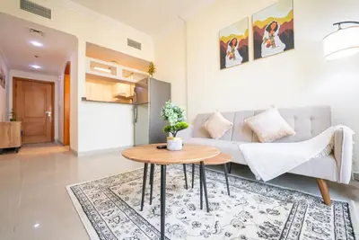 a living room with a couch and a table at Elegant Marina Living Manchester Tower in Dubai