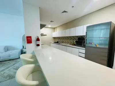 a kitchen with a white counter and a refrigerator at Vezul Residence, Business Bay - 2 Bedroom Apartment - Allsopp & Allsopp in Dubai