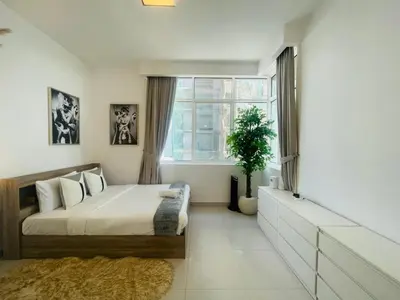 a bedroom with a large bed and a window at Vezul Residence, Business Bay - 2 Bedroom Apartment - Allsopp & Allsopp in Dubai
