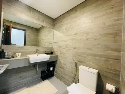 a bathroom with a white toilet and a sink at Vezul Residence, Business Bay - 2 Bedroom Apartment - Allsopp & Allsopp in Dubai