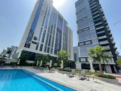 a swimming pool in a city with tall buildings at Vezul Residence, Business Bay - 2 Bedroom Apartment - Allsopp & Allsopp in Dubai