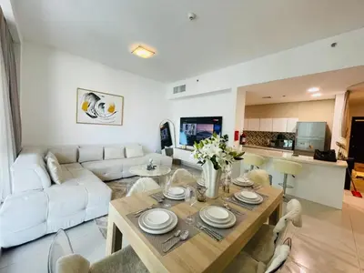 a living room with a white couch and a table at Vezul Residence, Business Bay - 2 Bedroom Apartment - Allsopp & Allsopp in Dubai