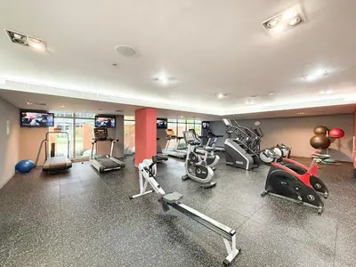 a gym with several exercise equipment in a room at Lux Unit Breathtaking Burj View I Walk Dubai Mall in Dubai