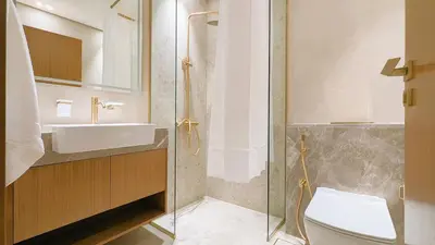 a bathroom with a sink and a toilet at Sleek and Cozy Studio, Private Jacuzzi, Canal View in Dubai