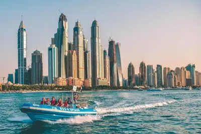 a group of people on a boat in the water with a city at Bright Apartment with Large Balcony and Water View in JBR in Dubai