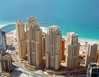 an aerial view of a city with tall buildings at Bright Apartment with Large Balcony and Water View in JBR in Dubai