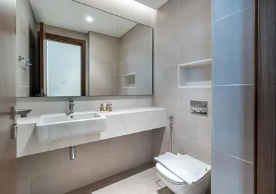 a bathroom with a sink and a toilet and a mirror at Canal Front Residence 5, Al Wasl - 2 Bedroom with Maids room - Allsopp & Allsopp 02 in Dubai