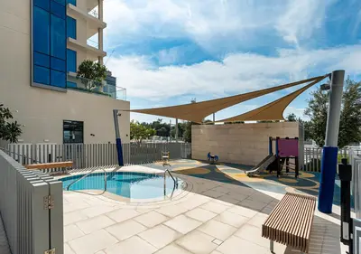 a swimming pool with a canopy over a building at Canal Front Residence 5, Al Wasl - 2 Bedroom with Maids room - Allsopp & Allsopp 02 in Dubai