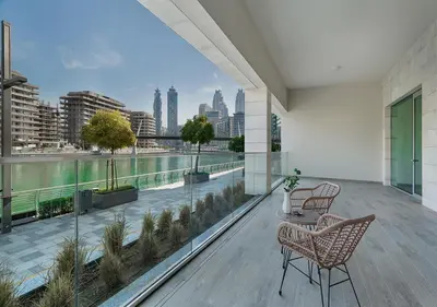 a balcony with two chairs and a view of the city at Canal Front Residence 5, Al Wasl - 2 Bedroom with Maids room - Allsopp & Allsopp 02 in Dubai