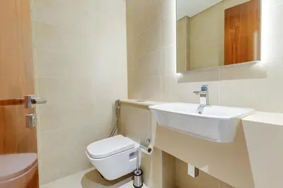 a bathroom with a white toilet and a sink at The Residences Marina Gate 1 - 2 Bedroom Apartment - Allsopp & Allsopp in Dubai