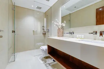 a bathroom with a sink and a toilet and a mirror at The Residences Marina Gate 1 - 2 Bedroom Apartment - Allsopp & Allsopp in Dubai