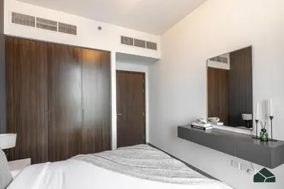 a bedroom with a bed and a large mirror at Serene 2BR with Sea View by BMS in Dubai