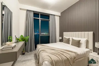 a bedroom with a large bed and a large window at Serene 2BR with Sea View by BMS in Dubai