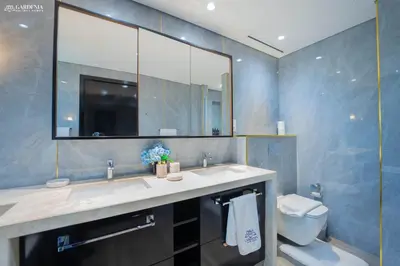 a bathroom with a sink and a toilet and a mirror at Blvd Point-Full Burj Khalifa View-Downtown in Dubai