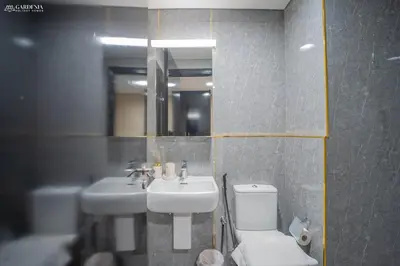 a bathroom with a sink and a toilet and a mirror at Blvd Point-Full Burj Khalifa View-Downtown in Dubai