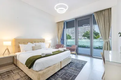 a bedroom with a large bed and a large window at Canal Front Residence 5, Al Wasl - 2 Bedroom with Maids room - Allsopp & Allsopp 01 in Dubai