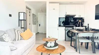 a living room with a white couch and a table at Stylish 1BDR Centrally Located for 4 Persons in Dubai