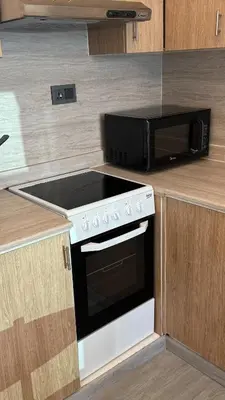 a kitchen with a stove and a microwave at 1BDR with Huge Balcony Stylish Living in Dubai
