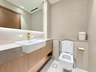 a bathroom with a white toilet and a sink at Binghatti Gardenia 2BHK in JVC in Dubai