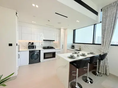 a kitchen with white appliances and a large window at Binghatti Gardenia 2BHK in JVC in Dubai