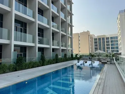 a swimming pool in front of a building at Boutique-Style Luxury Studio in Hyde Walk in Dubai