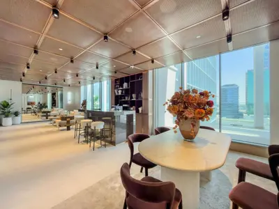a lobby with a table with a vase of flowers on it at Boutique-Style Luxury Studio in Hyde Walk in Dubai