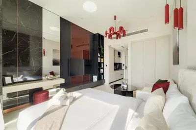 a living room with a white couch and a table at Boutique-Style Luxury Studio in Hyde Walk in Dubai