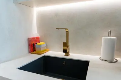 a kitchen counter with a sink and a faucet at Sleeps 3 Studio JVC I Fully Furnished I Central in Dubai